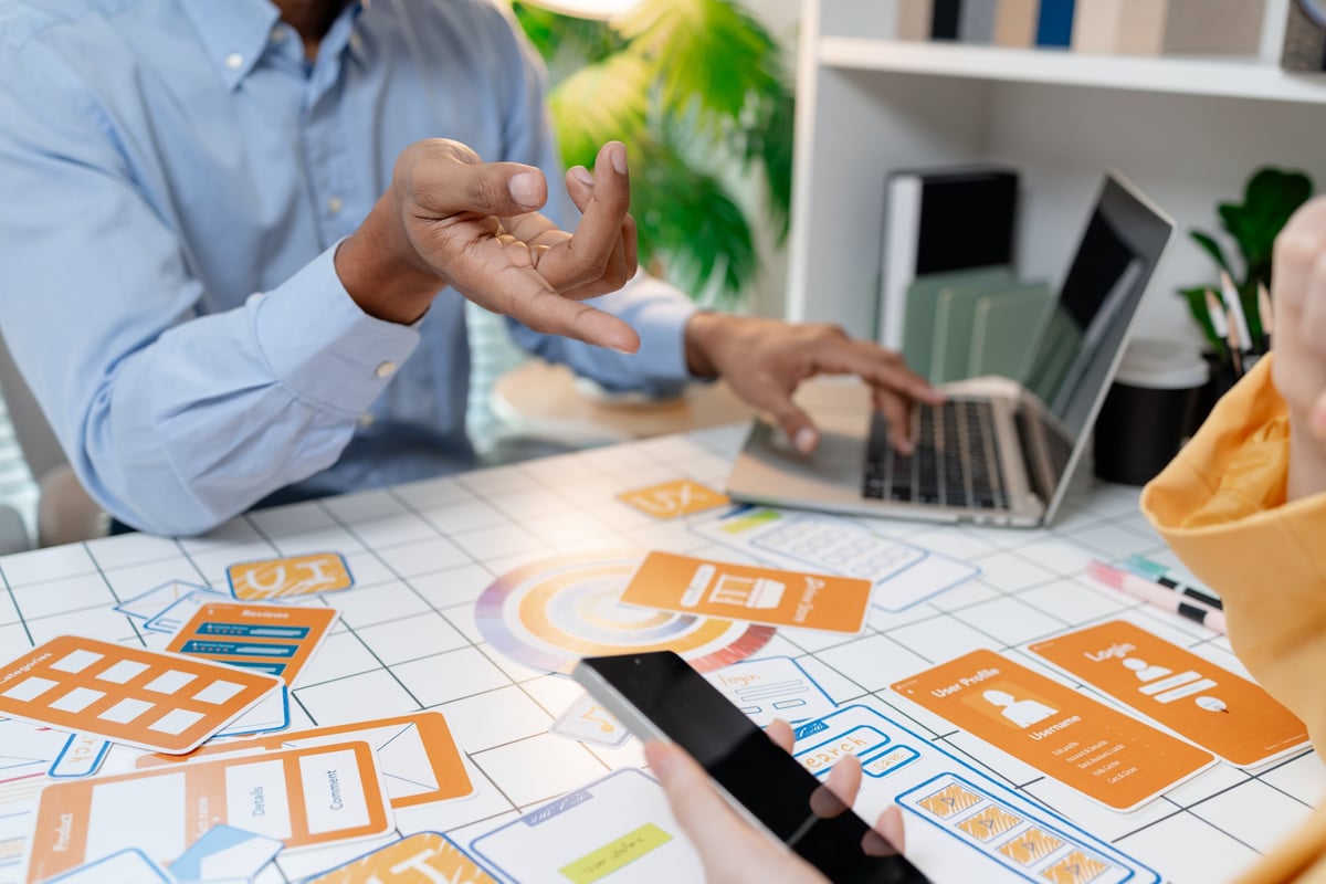 Designer walking a client through website wireframes and page layouts